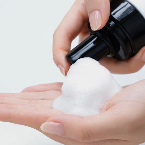 CHARISMA eyelash shampoo foam on a lash cleansing brush
