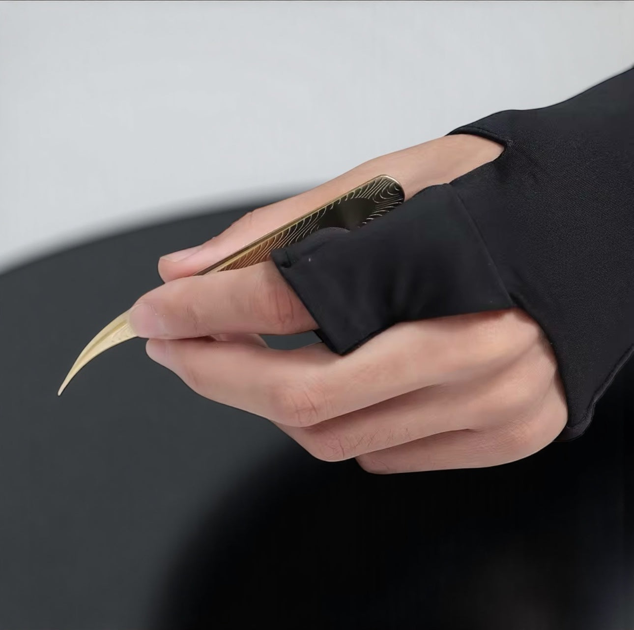 Lash artist curing extensions with the LED glove and any tweezer